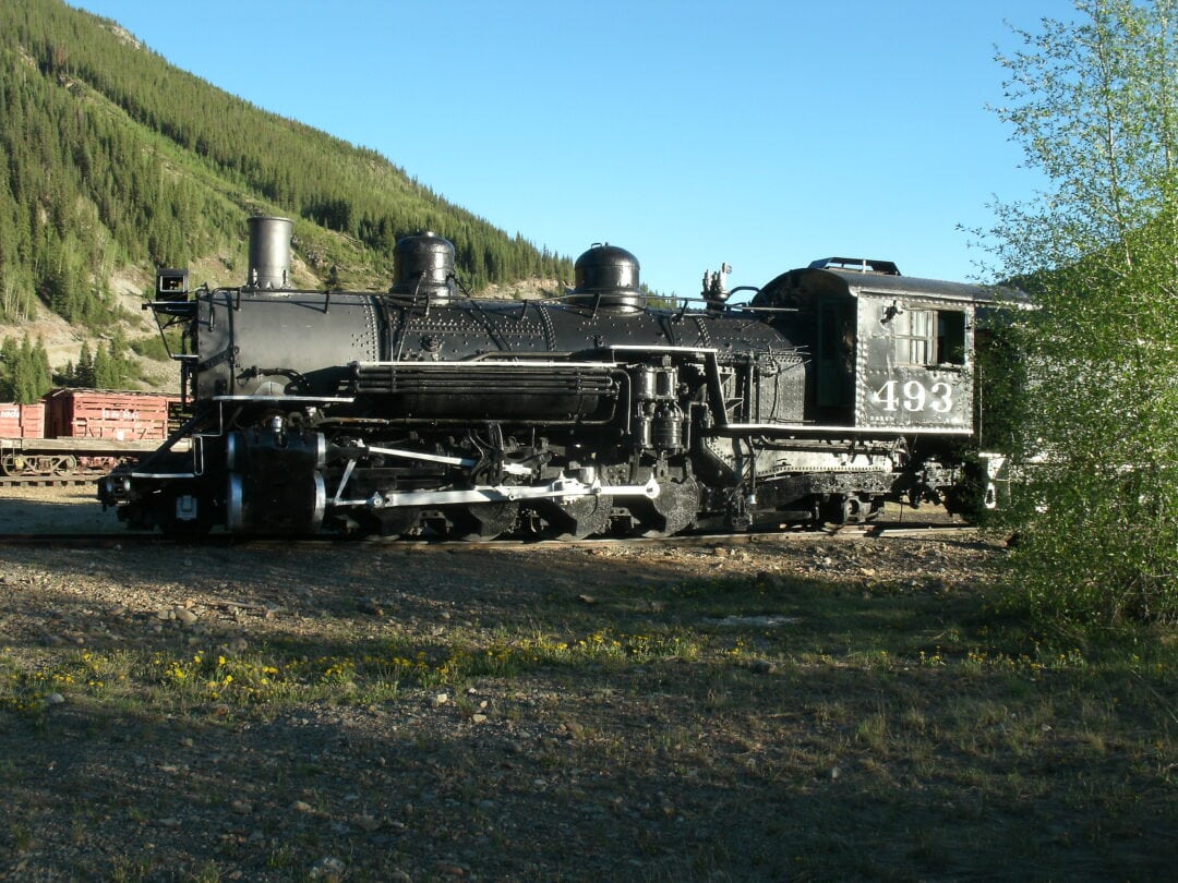 A railroad train stands still on the rails.